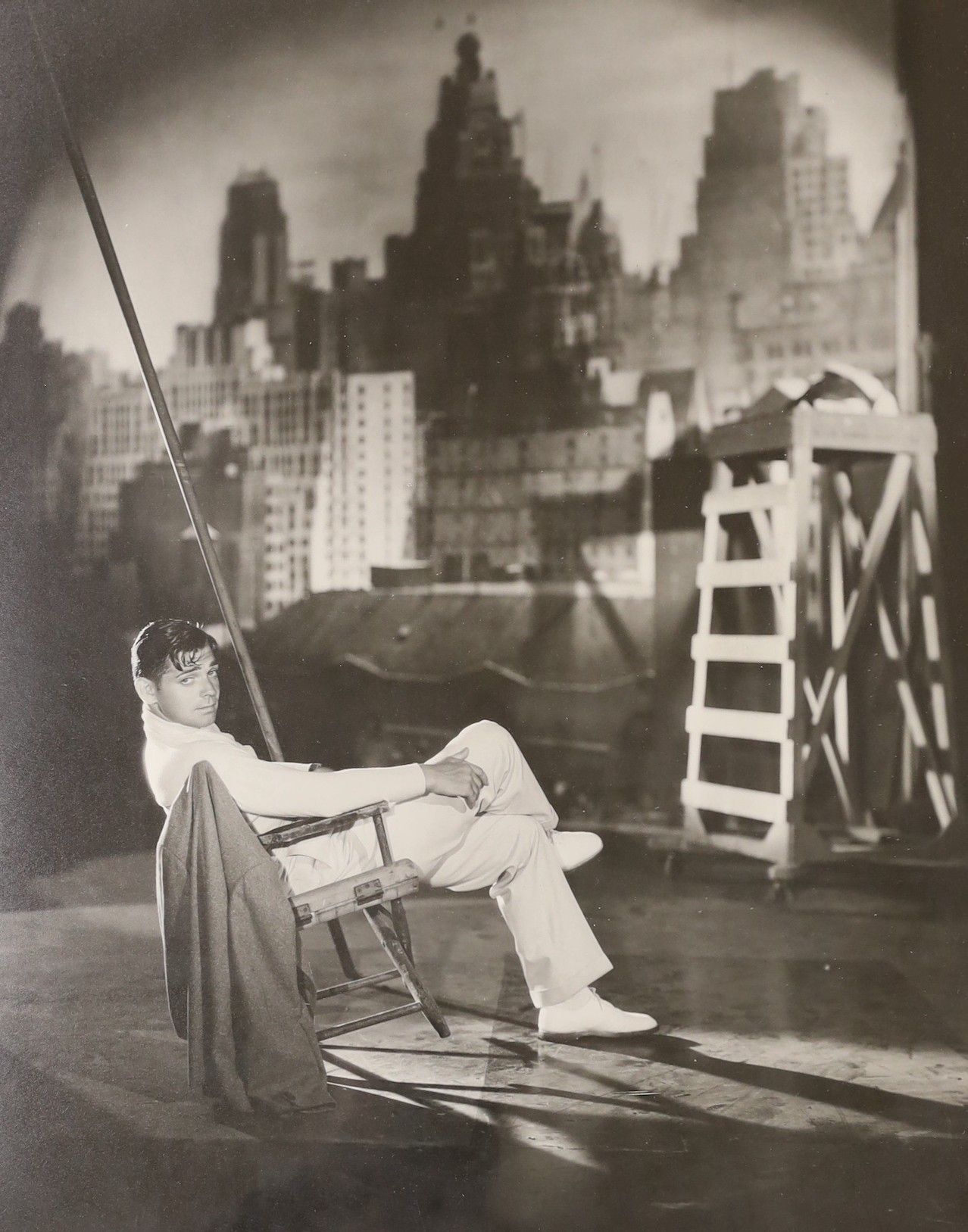 George Hurrell (photographer 1904-1992), photograph, Clark Gable reclining on a chair on a New York roof top, dated 1931, 50 x 40cm